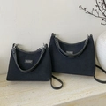 Black canvas dumpling handbags in two sizes with leather handles and minimal branding - Large / Black