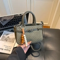 Dark green woven handbag with bead tassel and adjustable leather strap in mini size - Green