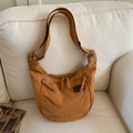 Brown canvas hobo crossbody bag featuring fringe zippers and an adjustable shoulder strap - Brown
