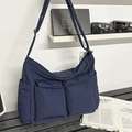 Quilted nylon messenger bag in navy blue with oversized front pockets and wide strap - Blue