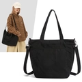 Dettaglio della borsa tote in nylon nero con trama del tessuto e tracolla regolabile - Nero