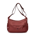 Detailed view of dark red nylon crossbody bag with multi-pocket design and adjustable strap - Red