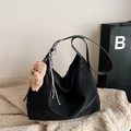 Black matte hobo shoulder bag with plush bear charm and woven rope on soft rug - With Charm / Black