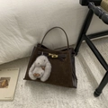 Detail of vintage brown suede bucket bag with leather accents and plush rabbit charm - Suede Coffee With Pendant