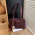 Close-up of deep burgundy vintage shoulder bag with matte leather and teddy bear charm - With Charm / Burgundy