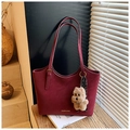 Retro burgundy leather tote bag with dog charm and silk scarf on a sunny wooden surface - Wine Red With Pendant