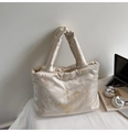 Detailed view of champagne satin tote bag with traditional Chinese embroidery and padded texture - Beige