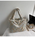 Detailed texture of satin fabric with gold Chinese architecture patterns on a grey tote bag - Green