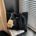 Black leather tote bag with gold metal buckle and cute brown plush bear charm accessory - With Charm / Black