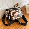 Brown zebra print crossbody bag with adjustable wide black strap and silver hardware - Brown