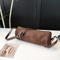 Detailed view of leopard print cylinder bag with suede texture and metal zipper - Coffee Leopard