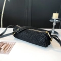 Detail of leopard print cylinder bag with gold zipper and contrast stitching strap - Black Leopard