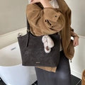 Close-up of matte vintage tote bag with gold logo and plush keychain on a shoulder strap - Coffee with Pendant