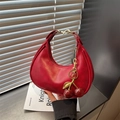 Chic red half-moon underarm bag with a cherry charm and glossy leather texture - With Charm / Red