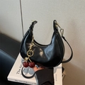 Minimalist black crescent shoulder bag with cherry charm and gold-tone hardware - With Charm / Black
