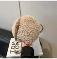 Detailed macro view of beige lamb wool texture and brown leather strap on round crossbody bag - Khaki