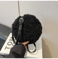 Close-up of black fluffy faux lamb wool round shoulder bag with adjustable leather strap - Black