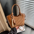 Chic caramel brown bucket bag with woven texture and beaded tassel accessory - Brown