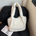 Plush white faux fur tote bag with soft shaggy texture on a black striped chair - White