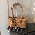 Chic brown faux leather shoulder bag with decorative buckle and cute plush bear charm - With Charm / Brown