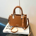Brown crossbody handbag with lychee texture leather and woven handle detail - Brown
