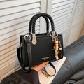 Black litchi grain leather bag with woven handle and colorful wooden bead charms - Black