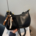 Black semi-circle hobo bag with gold zipper and decorative wooden bead charms - Black