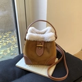 Brown suede bucket bag with white shearling trim and golden twist lock for autumn - Caramel color
