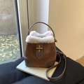 Brown suede bucket bag featuring white faux shearling trim and metallic turn-lock closure - Brown