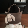 Brown lychee leather bucket bag with top handle and cute plush rabbit charm accessory - Coffee with Pendant
