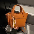 Braune Leder-Eimertasche mit Tragegriff, Riemen und Perlen-Schlüsselanhänger - Braun mit Anhänger