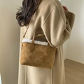Brown suede-texture bucket bag with white faux fur trim and embossed monogram pattern - Caramel color