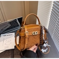 Detail of vintage brown tote bag with matte leather stitching and gold twist lock - Brown with Pendant