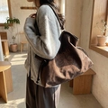 Brown suede tote bag with daisy embroidery and drawstring design on model - Coffee