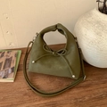 Detailed close-up of olive green crossbody bag with leather bow and silver hardware - Green