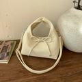 Detail of cream hobo bag with leather bow decoration and silver metal hardware - White