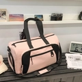 Pink large capacity travel bag with black straps on a table with vintage props - Pink