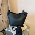 Minimalist black lychee leather bucket bag with white contrast stitching and top handles - Black without Pendant