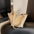 Modern beige lychee pattern bucket bag with wide strap on black leather surface - Rice White (No Pendant)