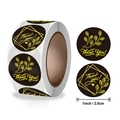 Gold foil Thank You stickers on a black roll for gift sealing, 1 inch round design - 2 Patterns / 1 Inch