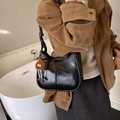 Minimalist black bucket shoulder bag in glossy PU with brown plush monster charm - Black With Pendant