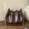 Dark brown glossy quilted bucket bag with golden chain strap for women - Brown