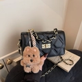 Black quilted crossbody bag with gold chain strap and plush puppy charm detail - With Charm / Black