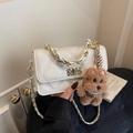 Cream quilted crossbody bag with gold chain strap and plush puppy charm detail - With Charm / Off-white