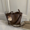 Close-up of dark brown lychee grain tote bag with cute white plush dog charm - With Charm / Brown