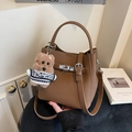 Brown litchi grain leather bucket bag with silver lock and plush bear charm - Coffee with Pendant