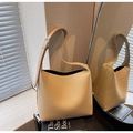 Detailed view of camel lychee grain leather tote bag with adjustable strap and wide handle - Beige Apricot