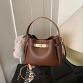 Brown litchi grain leather bucket bag with gold lock and white fur ball pendant - With Charm / Brown