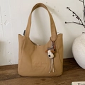 Detail view of khaki canvas tote with C'est la vie embroidery and plush dog charm - With Pendant / Brown