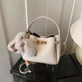 Ivory textured leather bucket bag with gold clasp and grey plush rabbit charm - With Charm / Beige Grey